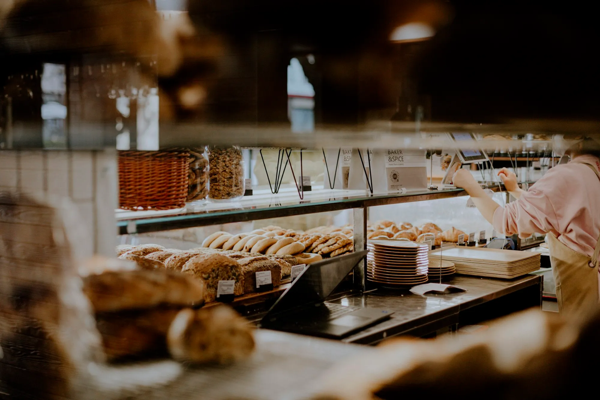 Bakery owner working behind the counter of her shop